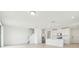 Open-concept living space flows into the kitchen with stairs leading to the upper level at 16430 Bird Of Paradise Ave, Clermont, FL 34714