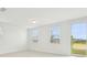 Spacious area with tiled floors, two windows and a sliding glass door that bring in light at 16430 Bird Of Paradise Ave, Clermont, FL 34714