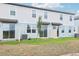 Backyard view of newly built townhomes, with small patios and young trees at 16434 Bird Of Paradise Ave, Clermont, FL 34714
