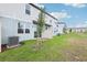 View of the backyard featuring townhomes, small patios and young trees at 16434 Bird Of Paradise Ave, Clermont, FL 34714