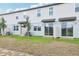 View of newly built townhomes with small patios and young trees at 16434 Bird Of Paradise Ave, Clermont, FL 34714