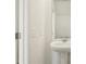 A pedestal sink with light switches displayed in this well-lit powder bathroom at 16434 Bird Of Paradise Ave, Clermont, FL 34714