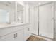 Bright bathroom featuring double vanity, and a glass enclosed shower at 16434 Bird Of Paradise Ave, Clermont, FL 34714