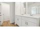 Bright bathroom featuring double vanity with wood-look tile floors at 16434 Bird Of Paradise Ave, Clermont, FL 34714