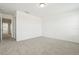 Bright bedroom features neutral carpet, white walls, and an open door to the hallway at 16434 Bird Of Paradise Ave, Clermont, FL 34714