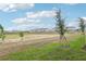 View of the community showcasing well-maintained landscaping, manicured lawns and stylish two-story residential buildings at 16434 Bird Of Paradise Ave, Clermont, FL 34714
