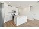 Bright kitchen with white cabinetry, stainless steel appliances, and an island offers an open, airy cooking space at 16434 Bird Of Paradise Ave, Clermont, FL 34714