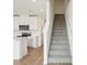 The staircase complements the kitchen's modern look, enhancing the flow and design of the living space at 16434 Bird Of Paradise Ave, Clermont, FL 34714