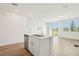 Island with double sinks offers a functional and stylish touch to the kitchen area, complementing the open floor plan at 16434 Bird Of Paradise Ave, Clermont, FL 34714