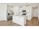Modern kitchen features white cabinets, stainless steel appliances, and a center island, perfect for cooking and entertaining at 16434 Bird Of Paradise Ave, Clermont, FL 34714