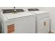 Front-loading washing machine and dryer with white finish in laundry area at 16434 Bird Of Paradise Ave, Clermont, FL 34714