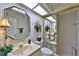 Inviting bathroom featuring a vanity with unique mirror and decor, plus enclosed shower and toilet at 2446 Sweetwater Country Club Dr, Apopka, FL 32712