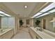 Spacious bathroom featuring double sinks, a garden tub, and illuminated by unique skylights at 2446 Sweetwater Country Club Dr, Apopka, FL 32712