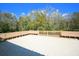 Overlooking trees under a beautiful sky, large deck is perfect for outdoor entertaining and relaxation at 2446 Sweetwater Country Club Dr, Apopka, FL 32712