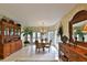 Charming dining area with abundant natural light from the windows, complemented by decorative furnishings at 2446 Sweetwater Country Club Dr, Apopka, FL 32712