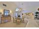 Bright dining room featuring a chandelier and large window, ideal for Gathering gatherings and elegant meals at 2446 Sweetwater Country Club Dr, Apopka, FL 32712