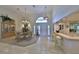 Formal dining room featuring elegant chandelier, large dining table, and wet bar at 2446 Sweetwater Country Club Dr, Apopka, FL 32712