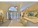 Inviting entryway with tile flooring, high ceilings, transom window, and adjacent bar area at 2446 Sweetwater Country Club Dr, Apopka, FL 32712