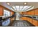 Modern kitchen featuring granite countertops, stainless steel appliances, and ample cabinet space at 2446 Sweetwater Country Club Dr, Apopka, FL 32712