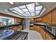 Well-equipped kitchen featuring stainless steel appliances and ample countertop space under a large skylight at 2446 Sweetwater Country Club Dr, Apopka, FL 32712