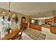 Well-lit kitchen and dining area with wooden cabinets, black countertops, and an adjacent breakfast nook at 2446 Sweetwater Country Club Dr, Apopka, FL 32712