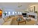 Cozy living room features a fireplace, plush seating, and plenty of natural light from the sliding doors at 2446 Sweetwater Country Club Dr, Apopka, FL 32712