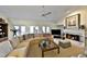 Cozy living room featuring a fireplace, large sofa, and access to the outdoors with French doors at 2446 Sweetwater Country Club Dr, Apopka, FL 32712