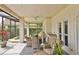 Inviting patio features wicker seating, a ceiling fan, and access to a built in sink and a serene backyard at 2446 Sweetwater Country Club Dr, Apopka, FL 32712