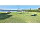 Community playground featuring swings and picnic tables near the lake, enhancing outdoor enjoyment at 2446 Sweetwater Country Club Dr, Apopka, FL 32712