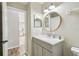 Well-lit bathroom featuring a vanity with a round mirror and modern fixtures at 360 Coventry Estate Blvd, Deltona, FL 32725