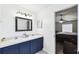 Well-lit bathroom features dual sinks with bright vanity lighting and a connecting door to the bedroom at 360 Coventry Estate Blvd, Deltona, FL 32725