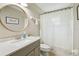 Bathroom with light colored vanity, sink, mirror, toilet, shower curtain and white trim at 360 Coventry Estate Blvd, Deltona, FL 32725