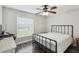 Bedroom with wood floors, a ceiling fan, and a metal frame bed, offering a cozy retreat at 360 Coventry Estate Blvd, Deltona, FL 32725
