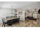 Open dining room with a rustic wood table, black chairs, and views to the living room and kitchen at 360 Coventry Estate Blvd, Deltona, FL 32725