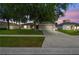 Charming single-story home featuring a well-manicured lawn, mature trees, and attached two car garage at dusk at 360 Coventry Estate Blvd, Deltona, FL 32725