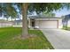 Inviting front yard with a well-maintained lawn, driveway, and two-car garage at 360 Coventry Estate Blvd, Deltona, FL 32725
