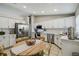 Bright kitchen with white cabinets, stainless steel appliances, tiled backsplash, and a cozy dining area at 360 Coventry Estate Blvd, Deltona, FL 32725