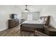 Bright main bedroom featuring a ceiling fan, wood-look flooring and natural light at 360 Coventry Estate Blvd, Deltona, FL 32725