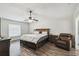 Spacious main bedroom with a large bed, ceiling fan, and wood-look flooring at 360 Coventry Estate Blvd, Deltona, FL 32725