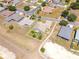 An aerial view shows homes in a planned residential community with palm trees and well maintained lawns at 829 Terranova Rd, Winter Haven, FL 33884