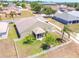 Aerial view of a house with lush landscaping and a white picket fence at 829 Terranova Rd, Winter Haven, FL 33884