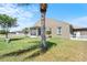 Home exterior with a screened-in patio overlooking lush landscaping and lawn at 829 Terranova Rd, Winter Haven, FL 33884