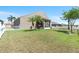 Spacious backyard with lawn, trees, flowers, and enclosed patio is perfect for entertaining at 829 Terranova Rd, Winter Haven, FL 33884
