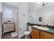 Bathroom with hardwood floors features a vanity, toilet, shower, and ample cabinet space at 829 Terranova Rd, Winter Haven, FL 33884
