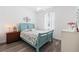 Cozy bedroom with hardwood floors features a large bed and a window with natural light at 829 Terranova Rd, Winter Haven, FL 33884