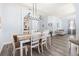 Well-lit dining room with stylish light fixture, hardwood floors, and neutral color palette at 829 Terranova Rd, Winter Haven, FL 33884