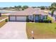 Beautiful home with a three-car garage, paver driveway, and well-manicured lawn at 829 Terranova Rd, Winter Haven, FL 33884