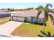 Stunning home boasts a three-car garage, paver driveway, and lush landscaping at 829 Terranova Rd, Winter Haven, FL 33884