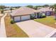 Gorgeous home with three-car garage, long paver driveway, and blue front doors at 829 Terranova Rd, Winter Haven, FL 33884