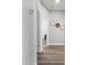 Hallway with hardwood floors and white walls leads to additional rooms with natural light at 829 Terranova Rd, Winter Haven, FL 33884